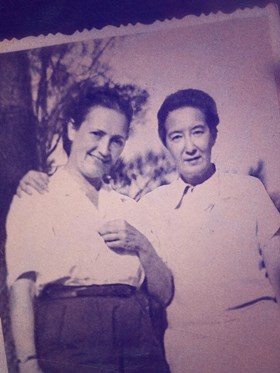 Nelly & Nadine documentary film - someone holds an old sepia photo of two women who look happy together
