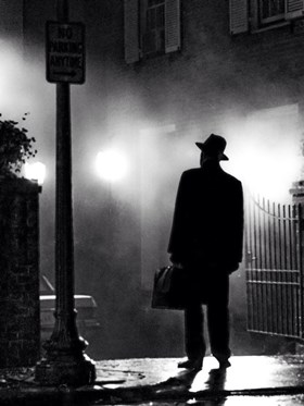 The Exorcist - silhouette of a man stood on the street in front of a house 